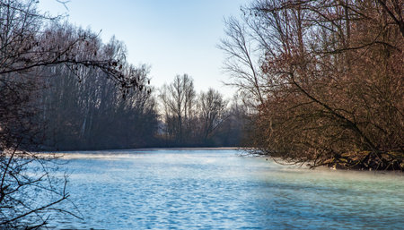Steaming, turquoise pond in winter on a sunny day, Bochum, Germanyの写真素材