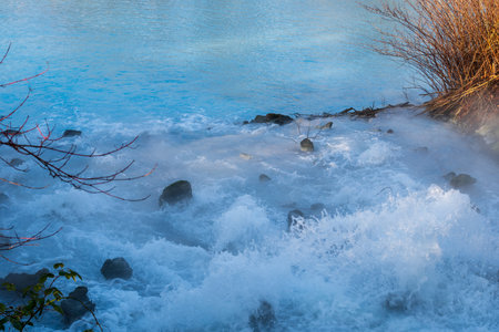 Bubbly introduction of turquoise mine water into a pond in Bochumの写真素材