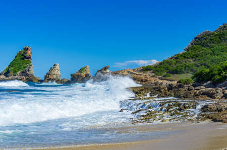 Breaking waves at rocks of the coast near Pointe des chateaux, Guadeloupe, Caribbeanの写真素材