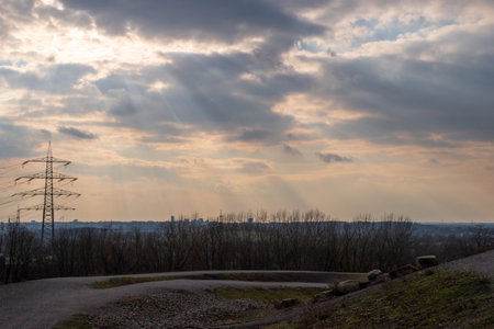 View over the Ruhr area, on the horizon the silhouette of the city of Essen, in dramatic light and cloudy skyの写真素材