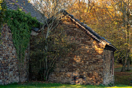 Old natural stone house in golden evening sunlightの写真素材