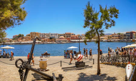 CHANIA, CRETE ISLAND, GREECE - JULY 12, 2019: A view of Kucuk Hasan Pasha Mosque and old Venetian Harbor promenade, beautiful historical buildings at Akti Tompazi street.のeditorial素材