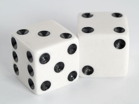 Two white dice with dots colored in black.
