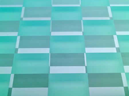 A glass checkerboard with clear and frosted squares with mirrored effect.の写真素材