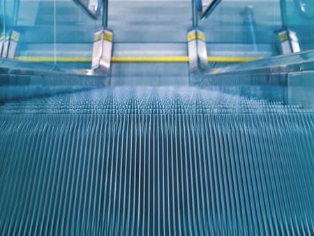 An airport escalator from the top landing showing motion blurの写真素材
