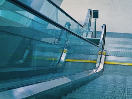 An airport escalator from the top landing showing motion blurの写真素材