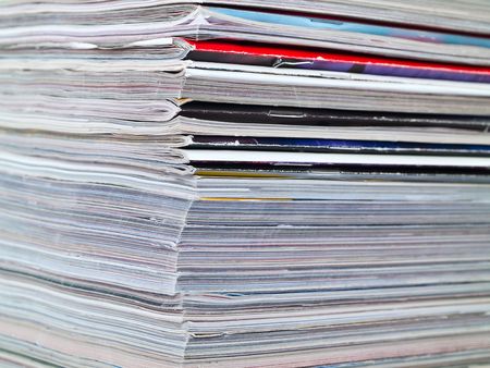 A stack of magazines filling the frame from top to bottom focus on corner edgeの写真素材