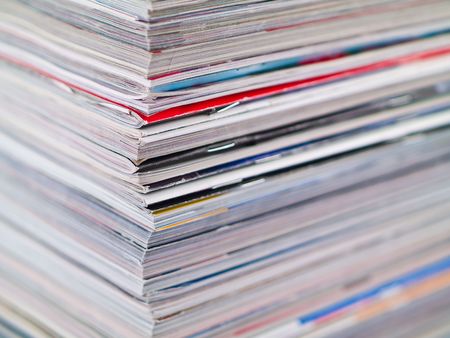 A stack of magazines filling the frame from top to bottom focus on corner edgeの写真素材