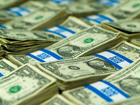 Hundred dollar bundles of U.S. One Dollar bill laid out as a backgroundの写真素材
