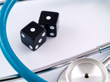 Black Dice and a Stethoscope Symbolizing a Health Gambleの写真素材