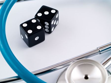 Black Dice and a Stethoscope Symbolizing a Health Gambleの写真素材