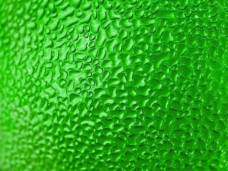 Water droplets formed from condensation inside a green bottleの写真素材