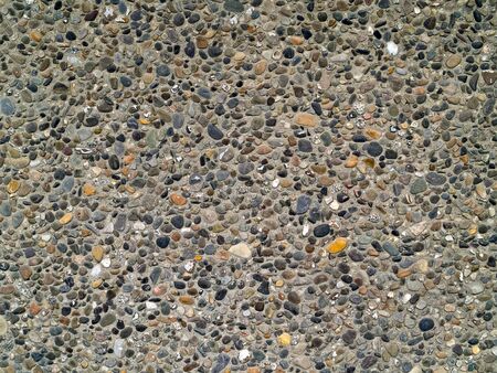Concrete wall made of small river rocksの写真素材