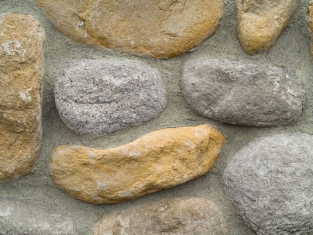 Rock and Concrete Wall with Large Rounded Stonesの写真素材