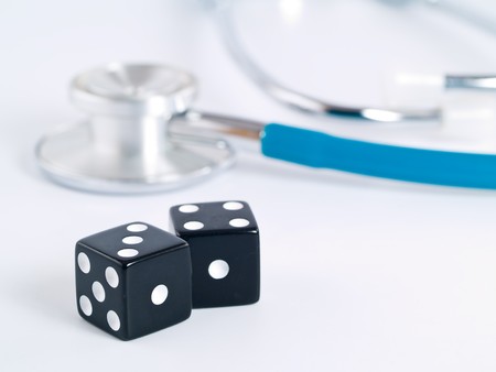 Stethoscope and Dice as a Gambling with your Health Conceptの写真素材