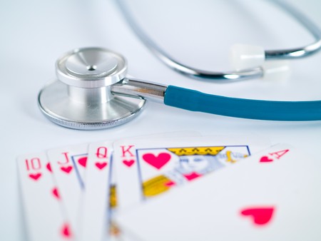 Stethoscope and Playing Cards as a Gambling with your Health Conceptのeditorial素材