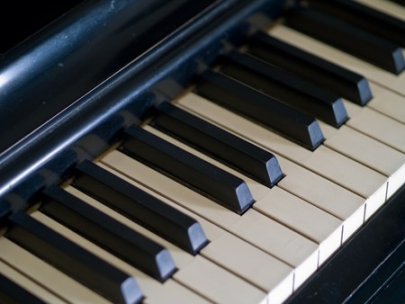 Piano keys of a very well loved and often played piano の写真素材