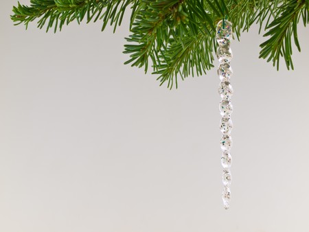Christmas Tree Holiday Ornament Hanging from a Evergreen Branch Isolatedの写真素材