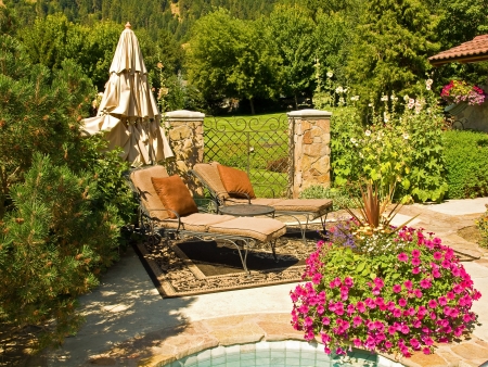 Two Empty Lounge Chairs in a Garden Settingの写真素材