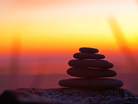 Stack of Five Flat Rocks on the Beach at Sunsetの写真素材