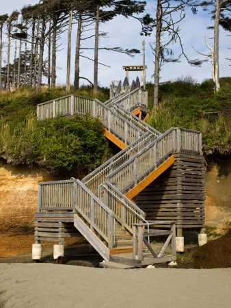 A Wooden Staircase Leading Down a Wooded Hillside to the Beachの写真素材
