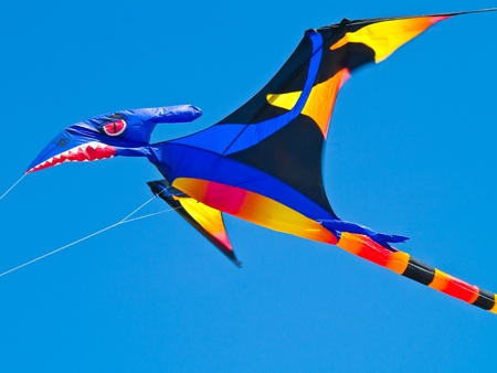 Colorful Pterodactyl Kite Flying in a Bright Blue Sky at the Long Beach Kite Festival