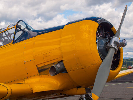 Vintage Yellow Propeller Aircraft Parked at an Airportのeditorial素材