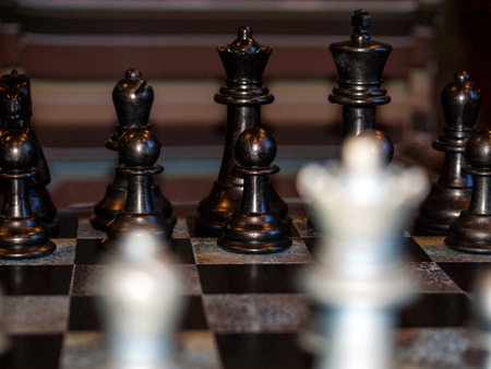 Wooden Chess Pieces on a Wooden Chessboardの写真素材