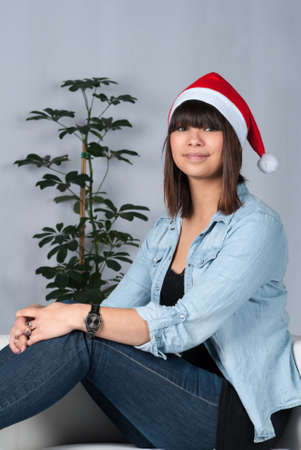 Cut out image of a young woman with a red white Christmas bobble hatの写真素材
