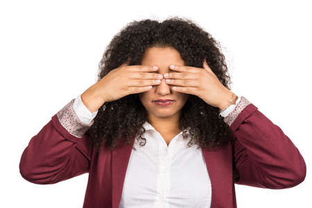Cut out image of a young woman with brown curly hair (afro) who covers her eyes with her hands.の写真素材