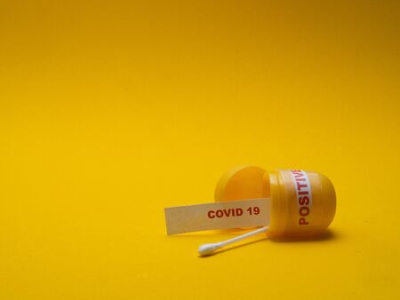 POSITIVE SAMPLES OF CORONA VIRUS ON YELLOW BACKGROUNDの写真素材
