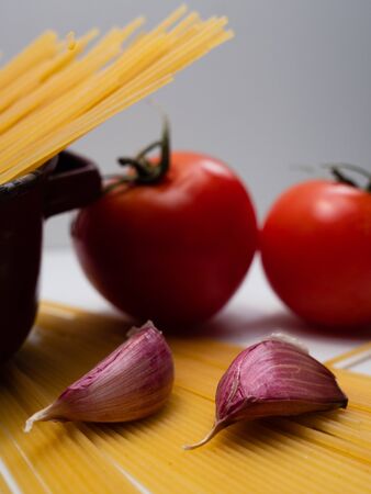 SPAGHETTI TOMATOES AND PURPLE GARLICの写真素材