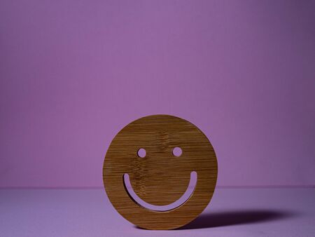 HAPPINESS IN WOOD ON PINK BACKGROUNDの写真素材