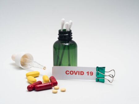 green dropper with pills around, with copy spaceの写真素材