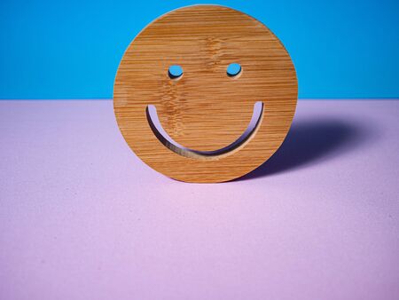 HAPPINESS IN WOOD ON PINK AND BLUE BACKGROUNDの写真素材