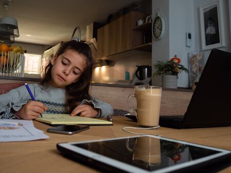 Daughter stay at home and doing homeworkの写真素材