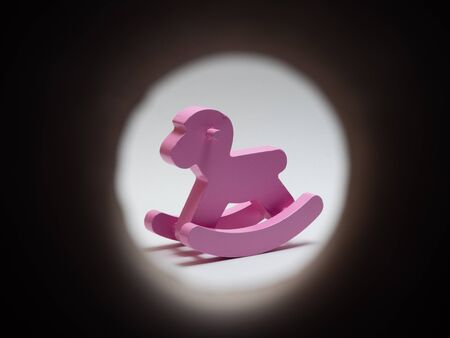 wooden pink horse rocker on white backgroundの写真素材