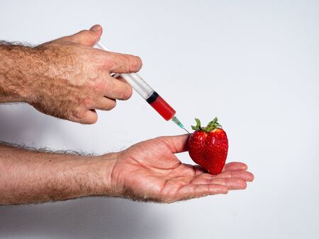 juice extracted with a syringe from a natural strawberryの写真素材