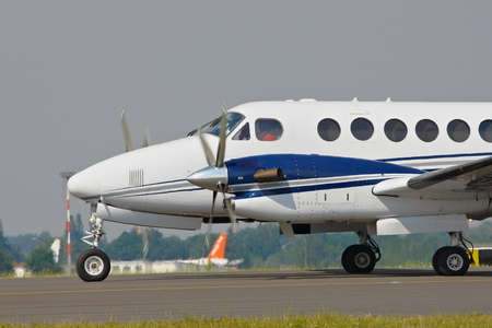corporate airplane on taxiway engine running