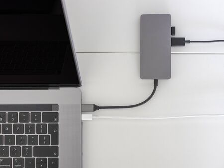 Laptop with usb-c hub on white desk