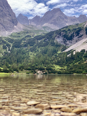 The beautiful Seebensee mountain lake with crystal clear water reflecting the surrounding mountains....