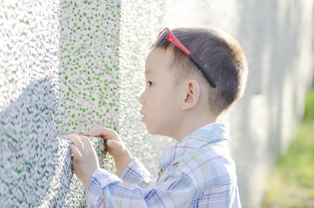 Side view of cute little boy outdoors in park