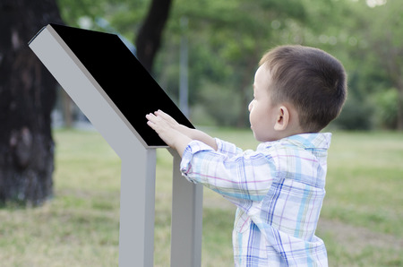 Child with a tablet comuputer outdoorの写真素材