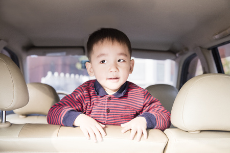 Cute boy traveling by carの写真素材
