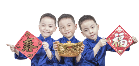 Happy young boy showing gold for chinese new yearの写真素材