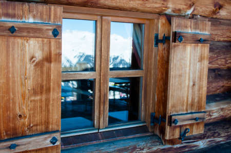 detail of alpine cottage window in snowy mountains of Montafon, Austriaの写真素材