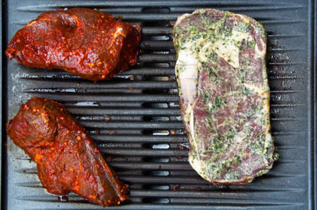 Assortment of steaks just put on the BBQ
