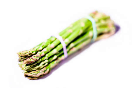 Abstract: Bunch of asparagus with creative coloring and focus isolated on a white backgroundの写真素材