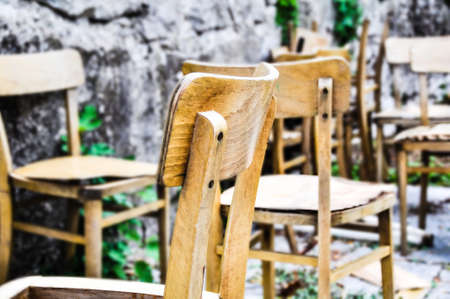 Vintage old school chairs rotting in a backyard, shallow depth of fieldの写真素材