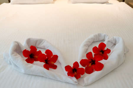 heart made from towels on honeymoon bedの写真素材